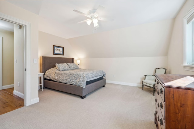 carpeted bedroom with ceiling fan and lofted ceiling