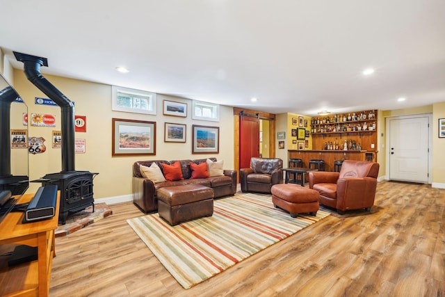 living room featuring bar area and light hardwood / wood-style floors