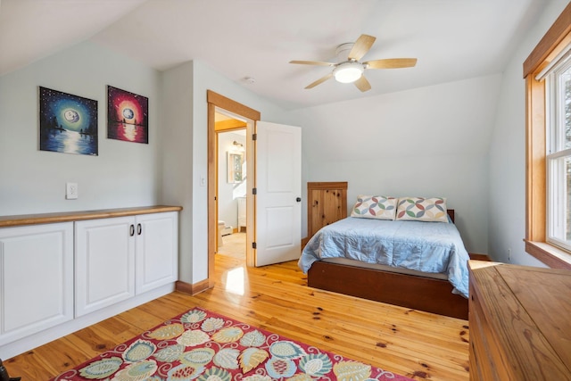 bedroom featuring light wood-type flooring, ceiling fan, vaulted ceiling, and multiple windows