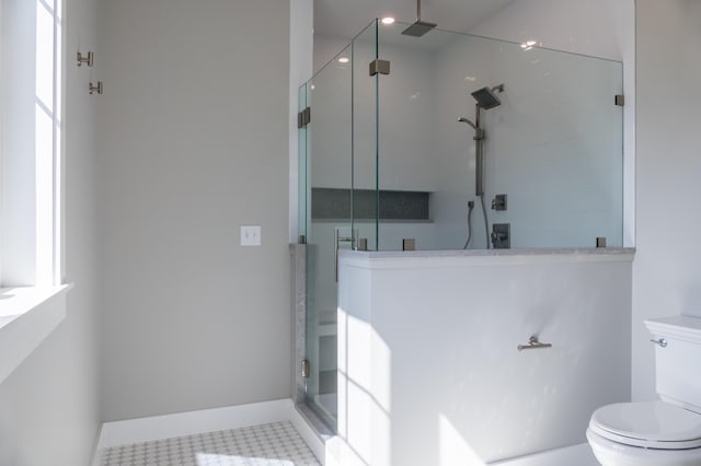 bathroom with walk in shower and toilet