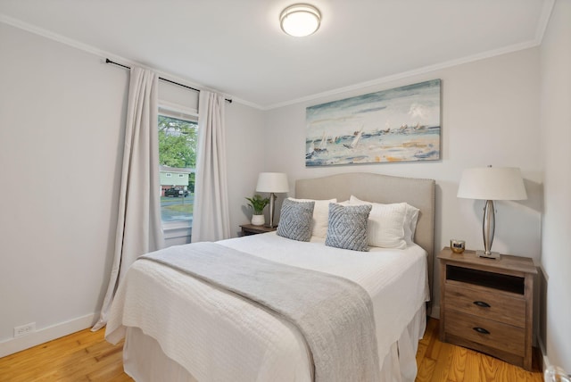 bedroom featuring wood-type flooring and ornamental molding