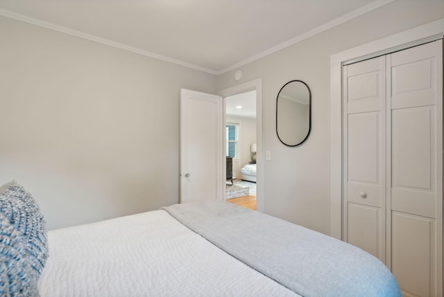 bedroom with a closet and crown molding