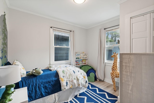 bedroom featuring light wood-type flooring and ornamental molding