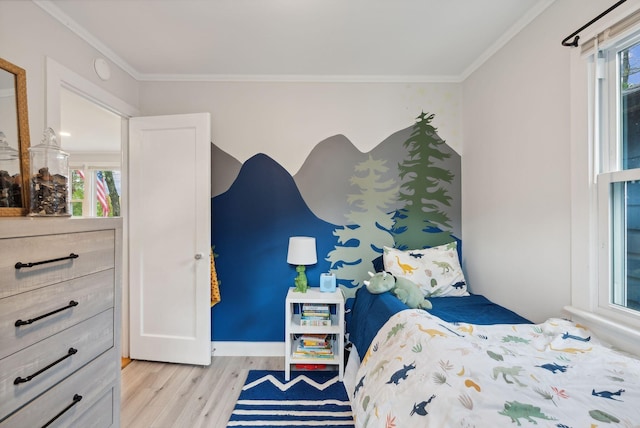 bedroom featuring ornamental molding and light wood-type flooring