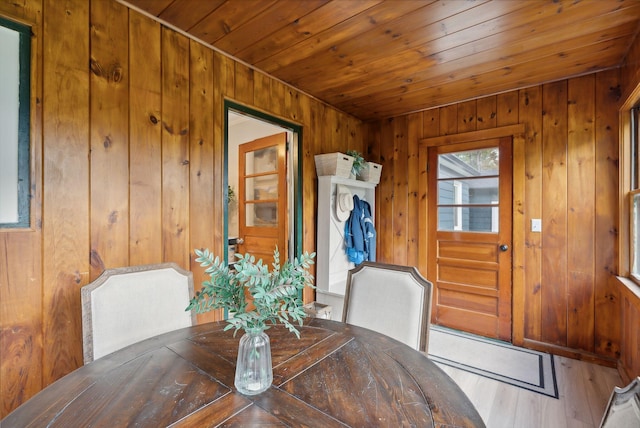 dining space featuring wood walls and hardwood / wood-style floors