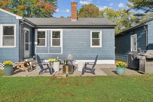 rear view of property with a patio area and a lawn