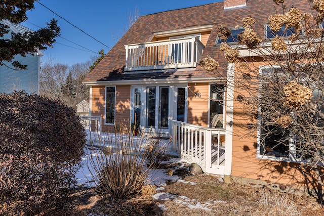 rear view of property with a balcony