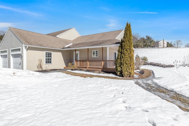 single story home with covered porch and an attached garage