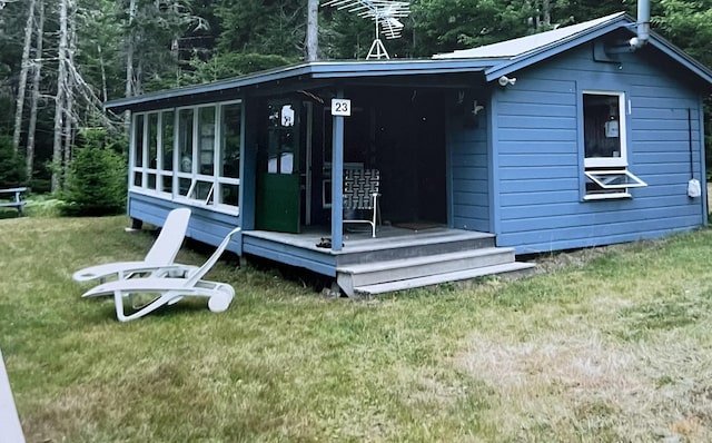 view of outdoor structure featuring a lawn