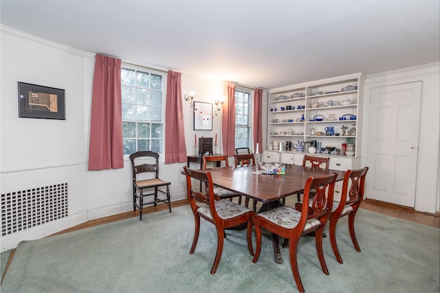 dining area with ornamental molding and radiator heating unit