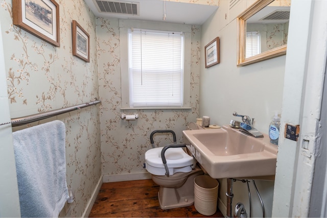 bathroom with toilet, wood-type flooring, and sink