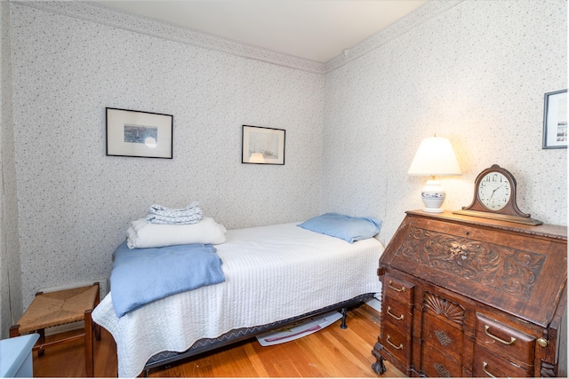 bedroom with hardwood / wood-style flooring