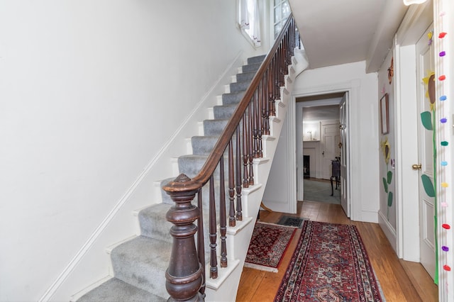 stairway with hardwood / wood-style flooring