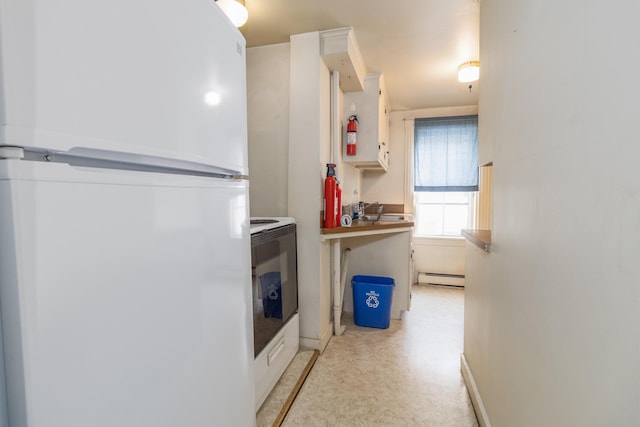 laundry room with stacked washer and clothes dryer and a baseboard radiator