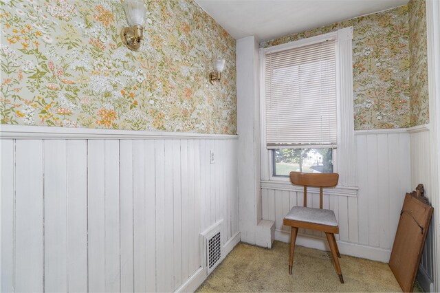 sitting room featuring light colored carpet