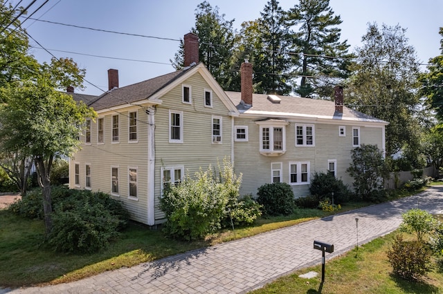 view of property exterior with a lawn