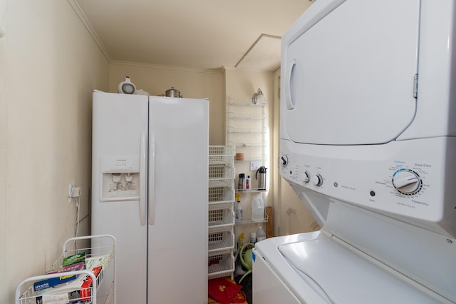 laundry room with stacked washing maching and dryer and crown molding