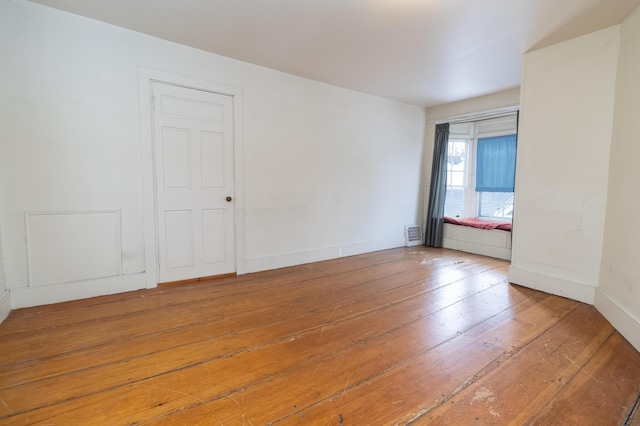 empty room with hardwood / wood-style floors