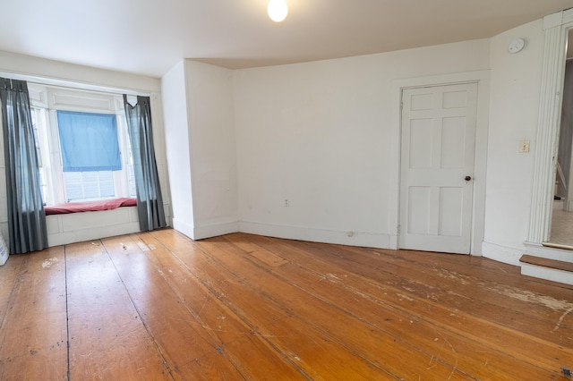 unfurnished room featuring hardwood / wood-style flooring