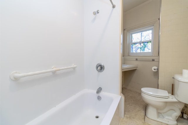 bathroom featuring toilet and  shower combination