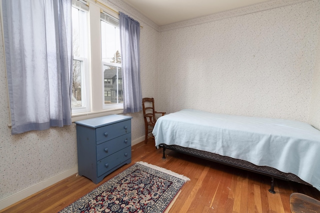 bedroom featuring ornamental molding and hardwood / wood-style flooring