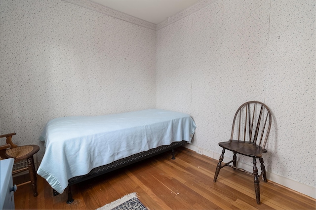 bedroom with hardwood / wood-style flooring