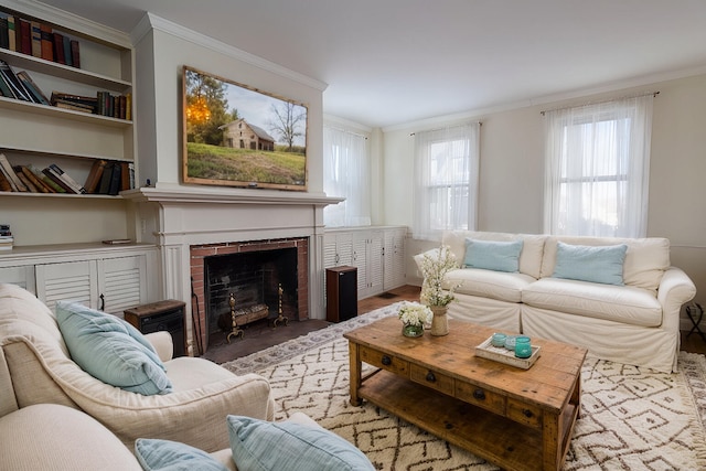 living room featuring a brick fireplace, crown molding, and hardwood / wood-style flooring