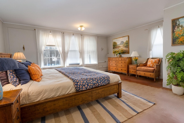 bedroom with hardwood / wood-style floors and crown molding