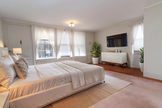 bedroom featuring ornamental molding and hardwood / wood-style floors