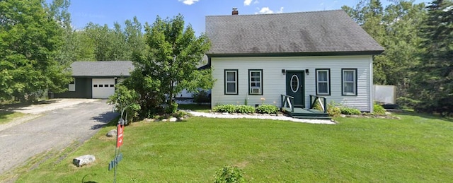 view of front of home with a front yard and a garage