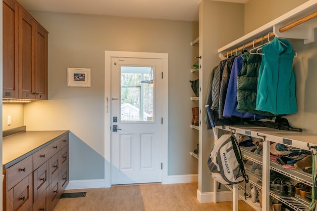 entrance foyer with light colored carpet and baseboards