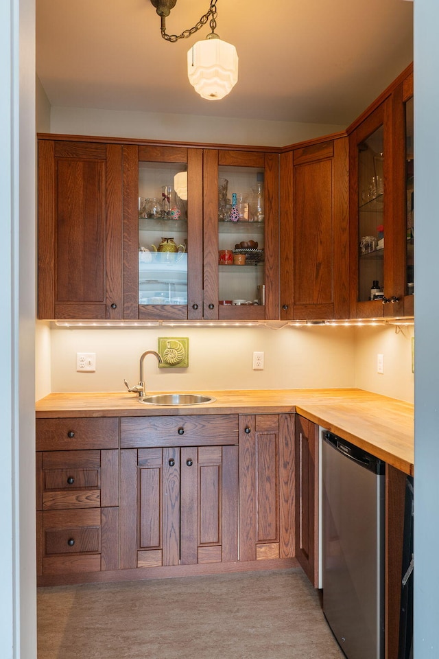bar featuring fridge, a sink, and hanging light fixtures