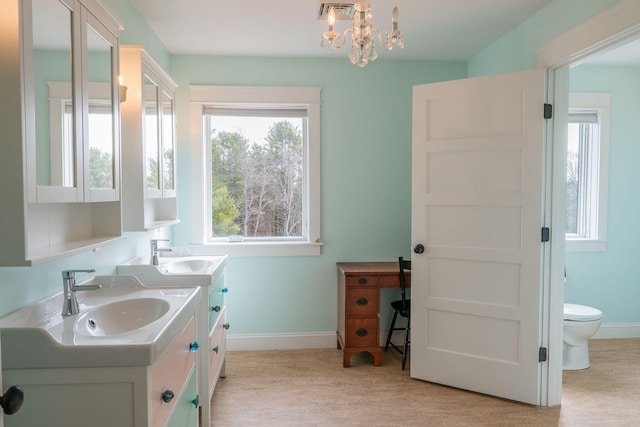 full bath with baseboards, vanity, and plenty of natural light