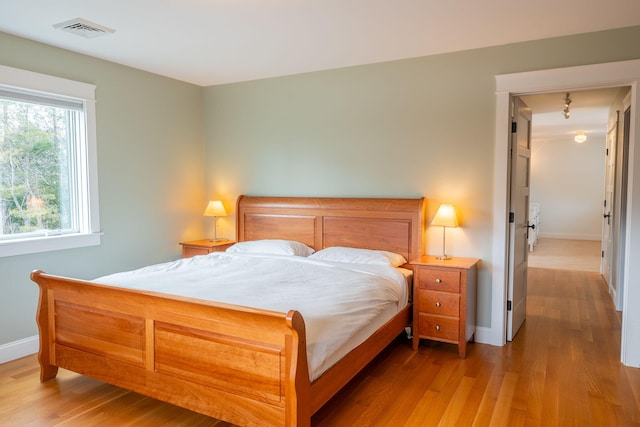 bedroom featuring baseboards and wood finished floors