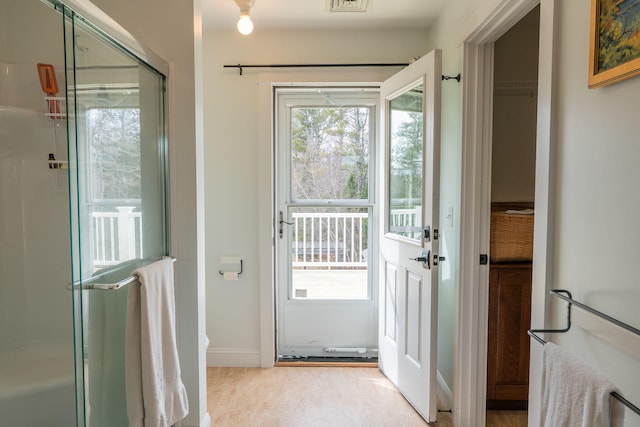 entryway featuring baseboards and carpet
