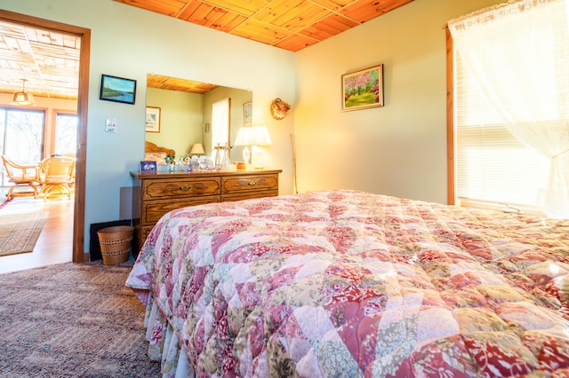 bedroom with carpet and wooden ceiling