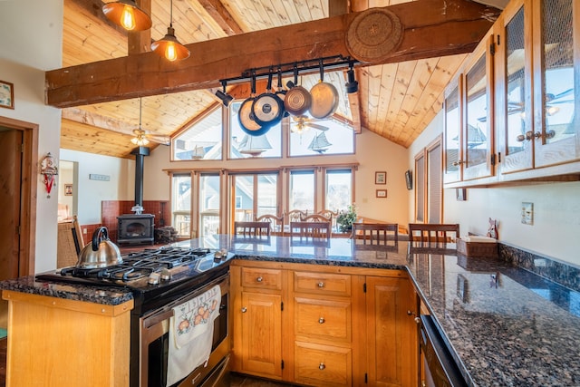 kitchen featuring pendant lighting, wood ceiling, kitchen peninsula, and stainless steel gas range oven