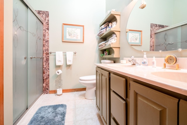 bathroom with vanity, tile patterned floors, toilet, and walk in shower