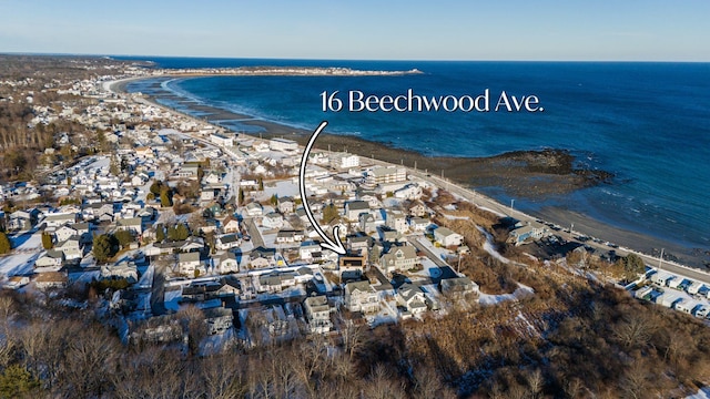 birds eye view of property with a water view and a beach view