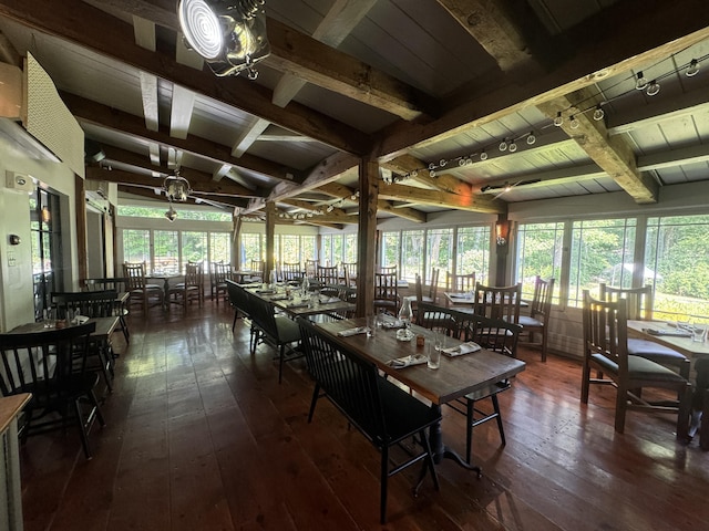 dining space featuring dark wood-type flooring, wood ceiling, and beam ceiling