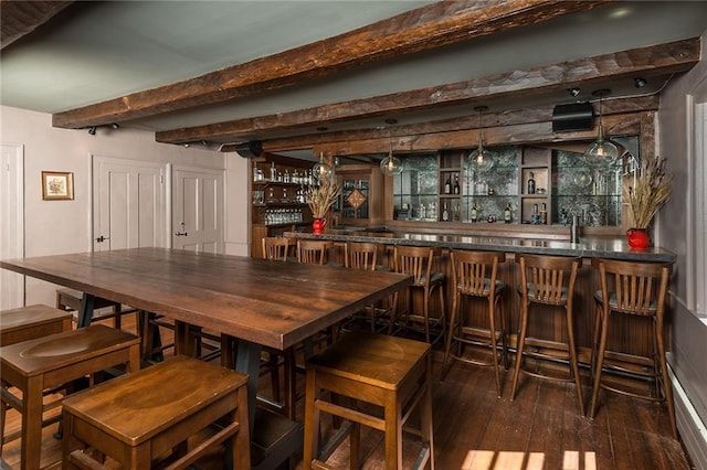 bar featuring dark wood-type flooring and beam ceiling