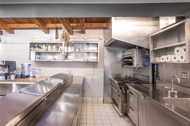 kitchen with beam ceiling, wooden ceiling, stainless steel counters, and sink