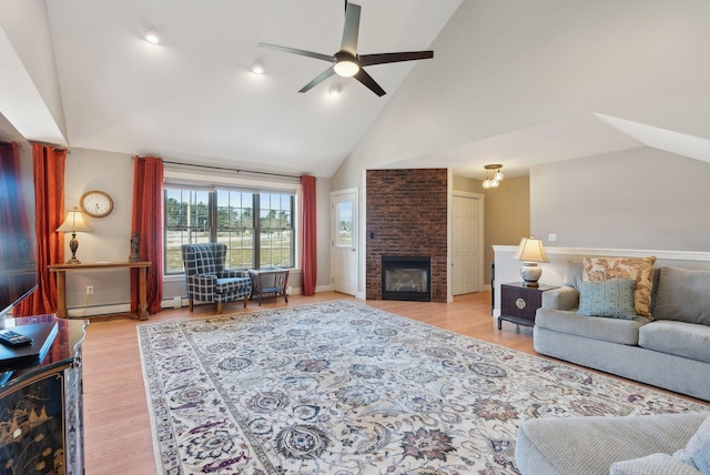 31 Estates Dr Unit 3, Manchester, ME 04351 - living room with ceiling fan, a baseboard heating unit, a brick fireplace, light hardwood / wood-style floors, and high vaulted ceiling