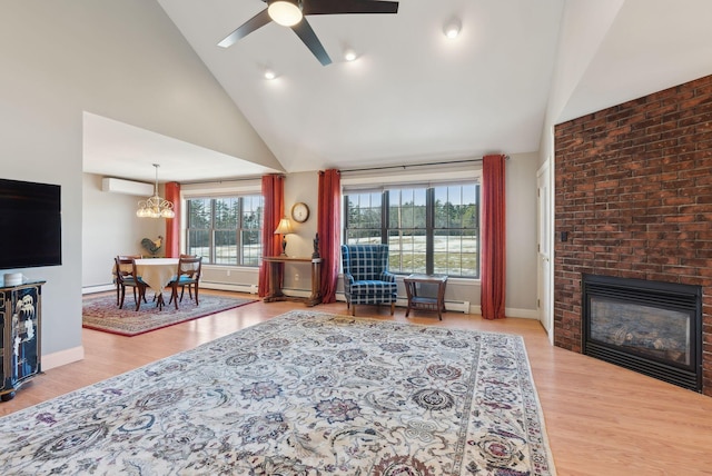 31 Estates Dr Unit 3, Manchester, ME 04351 - living room featuring a brick fireplace, a wealth of natural light, a wall mounted AC, and ceiling fan with notable chandelier