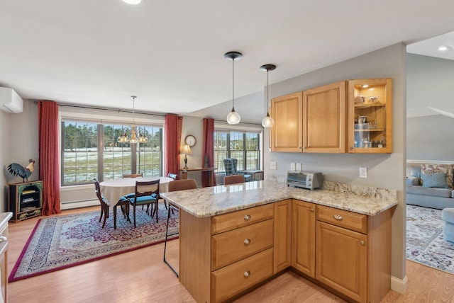 31 Estates Dr Unit 3, Manchester, ME 04351 - kitchen with a baseboard heating unit, pendant lighting, light hardwood / wood-style floors, and kitchen peninsula