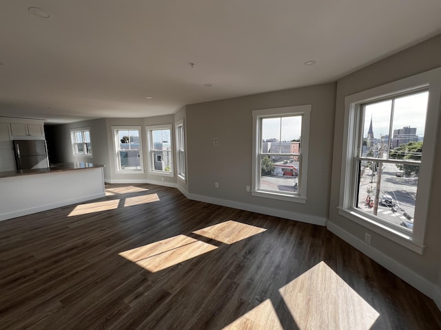 unfurnished living room featuring dark hardwood / wood-style flooring