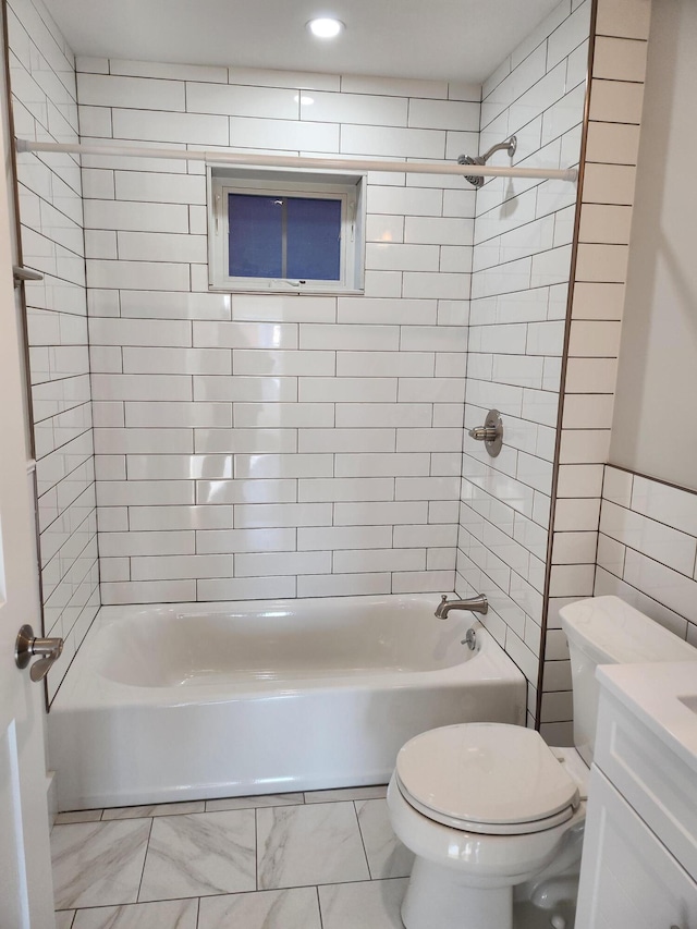 full bathroom with toilet, tiled shower / bath combo, and vanity