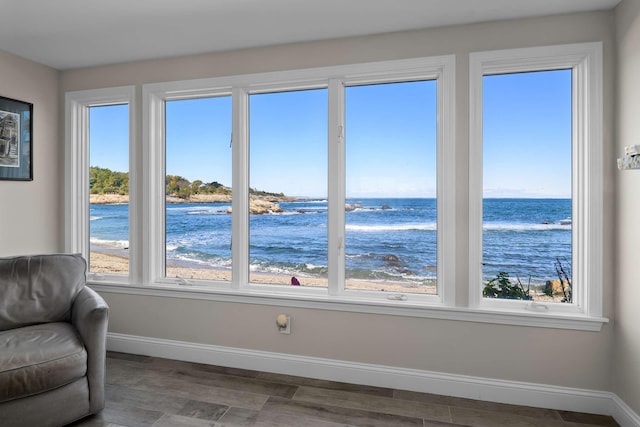 interior space with a beach view and a water view