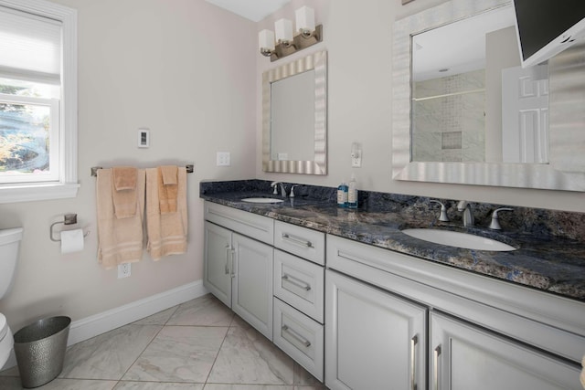 bathroom featuring a shower, vanity, and toilet