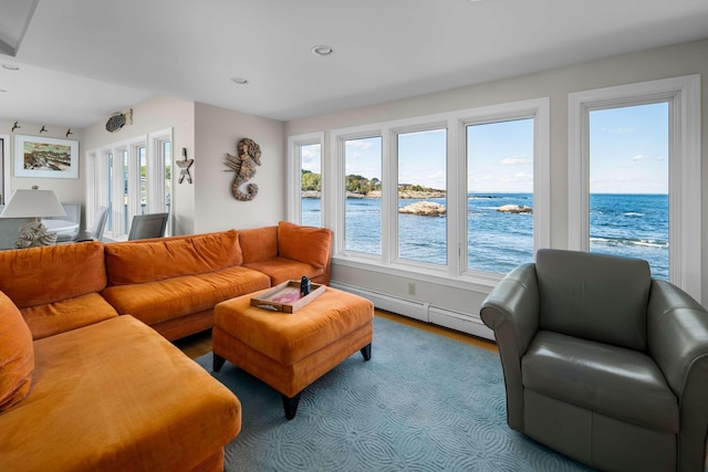 living room featuring a water view and a baseboard heating unit